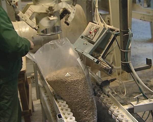 Worker pack pellets for burning to polythene bags. Organic fuel production in factory. 