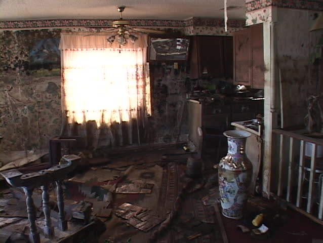 A team of workers clean up debris from a house flooded by Hurricane Katrina.