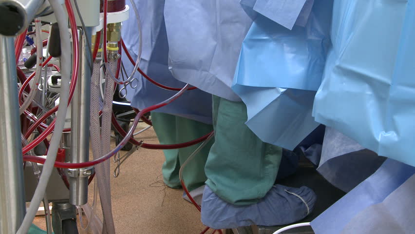 Feet of surgical team near bypass tubes