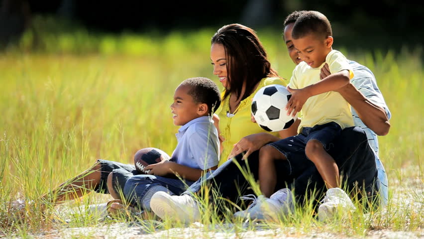Young ethnic family enjoying time together in the park