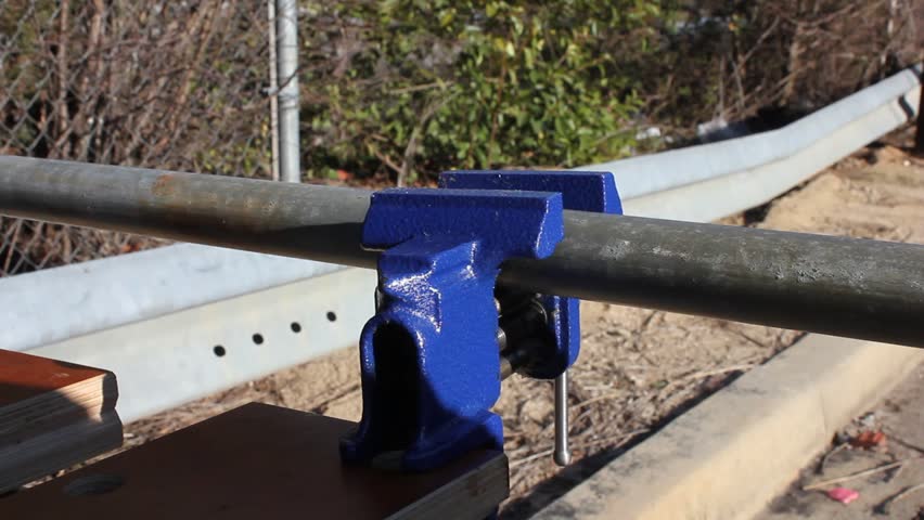 Metal Pipe Being Pulled Through A Loose Vise