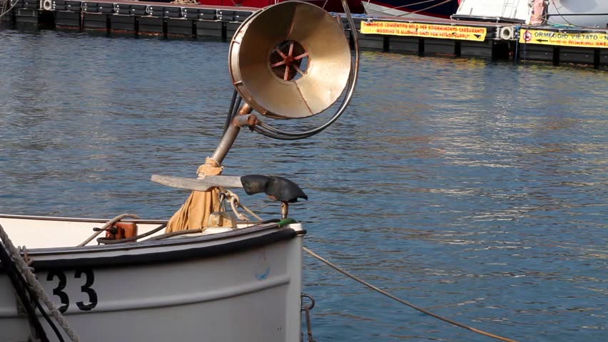 the bow with windlass of an old fishing boat. Porto Azzurro, Elba Island, Italy.