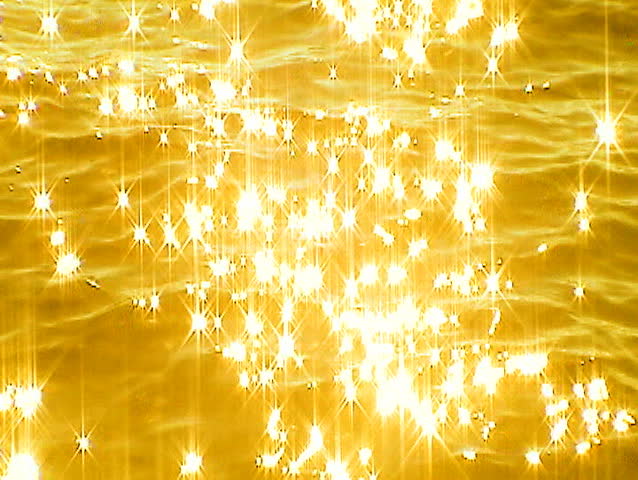 Sun reflections off lake water. Slowed down to show the play of sun's highlights and coloured with a golden tint.