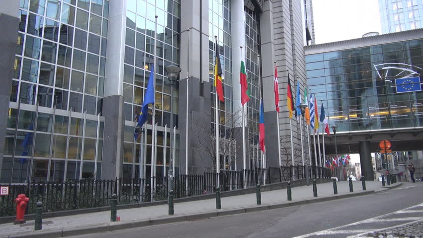 BRUSSELS, BELGIUM - DECEMBER 19 2011: Unidentified people and cars pass near to European Parliament 
