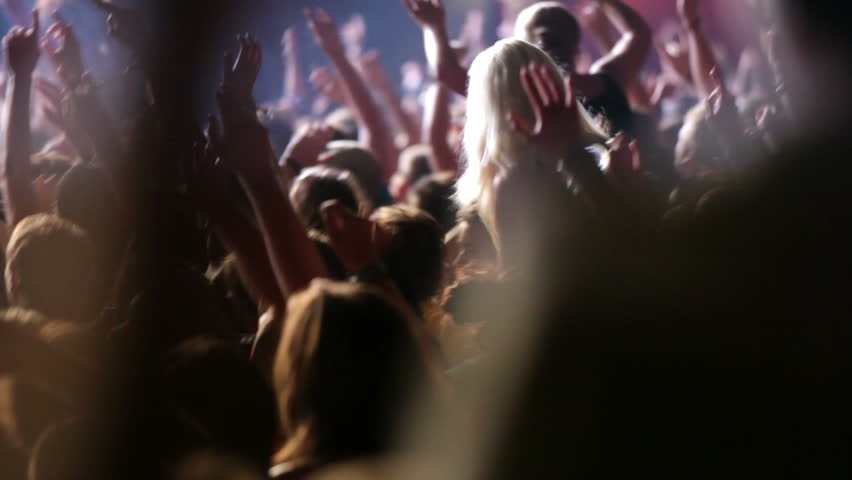 Footage of a crowd partying at a rock concert