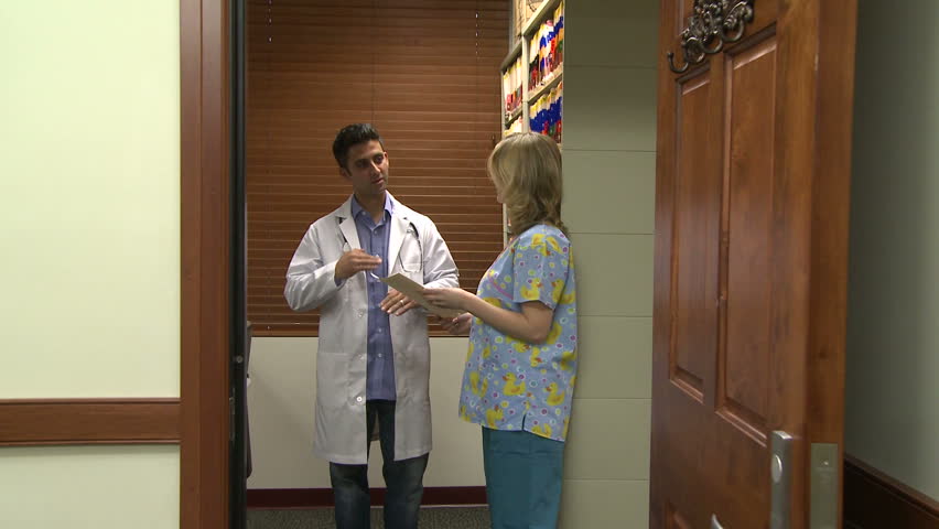 Doctor and nurse go over a chart