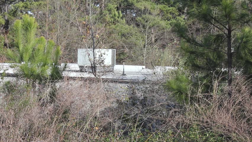 Rooftop With Air Conditioning Unit In Distance With Woods Foreground