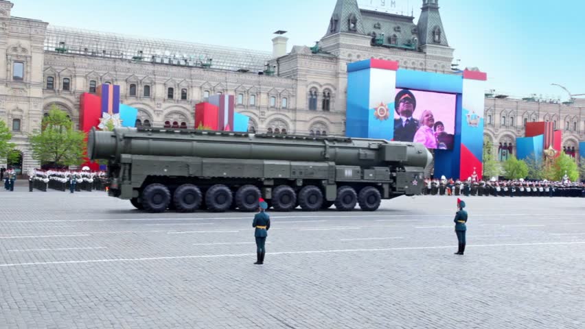 MOSCOW - MAY 9: Motorcade of rocket and carriers ride on Red square on Victory Parade at background of military orchestra near gum on May 9, 2011 in Moscow, Russia.