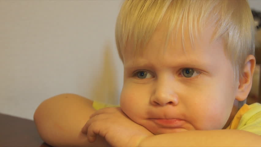 The blond boy watching TV. Emotions