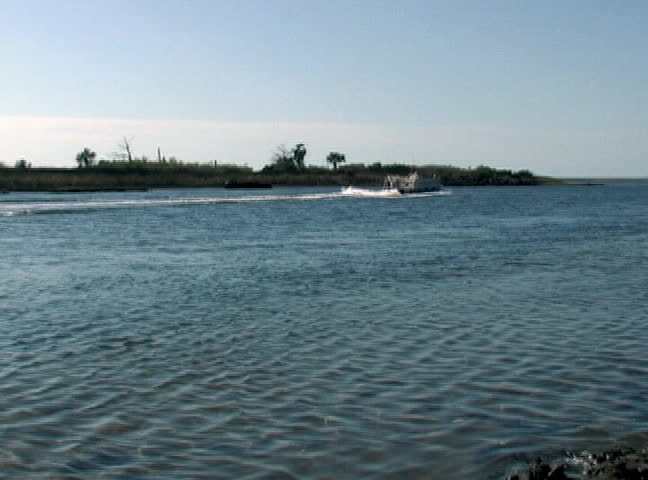 The pontoon boat motors out to the Gulf of Mexico from the mouth of the Withlacoochee River in Florida.