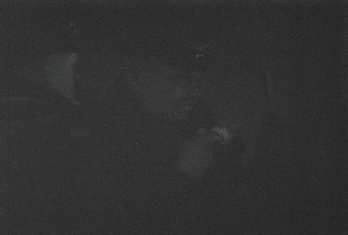 ATLANTIC OCEAN - CIRCA 1942-1944: World War II, Captain wipes off Binoculars At Night In Fog and scans the horizon