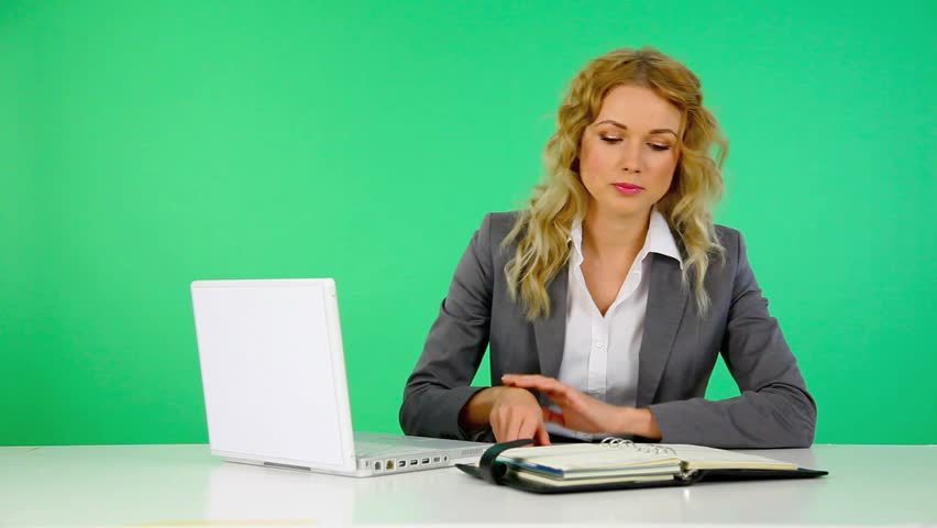 Businesswoman writing on agenda