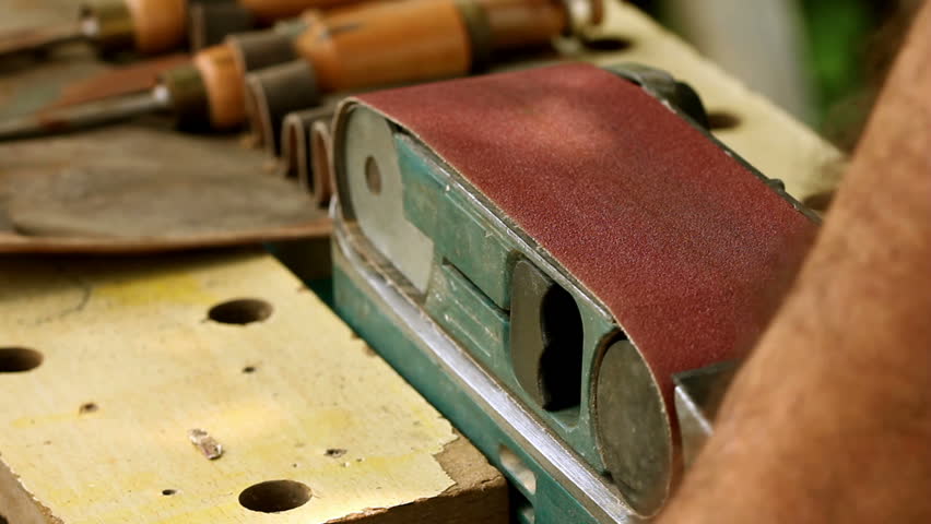 Carpentry tool sharpening on sand-paper close-up process