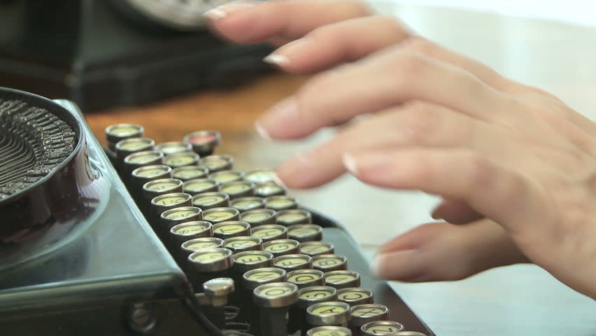 Woman typing on antique typewriter