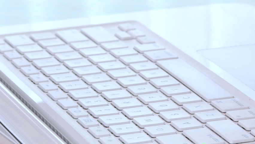 Close up of woman's fingers typing on laptop keyboard