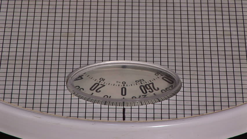 Woman stepping on a bathroom scale