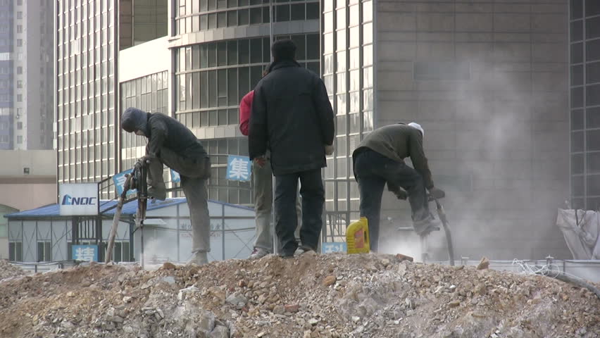 QINGDAO - MARCH 19: Workers are drilling at a construction site on March 19, 2010 in Qingdao, China.