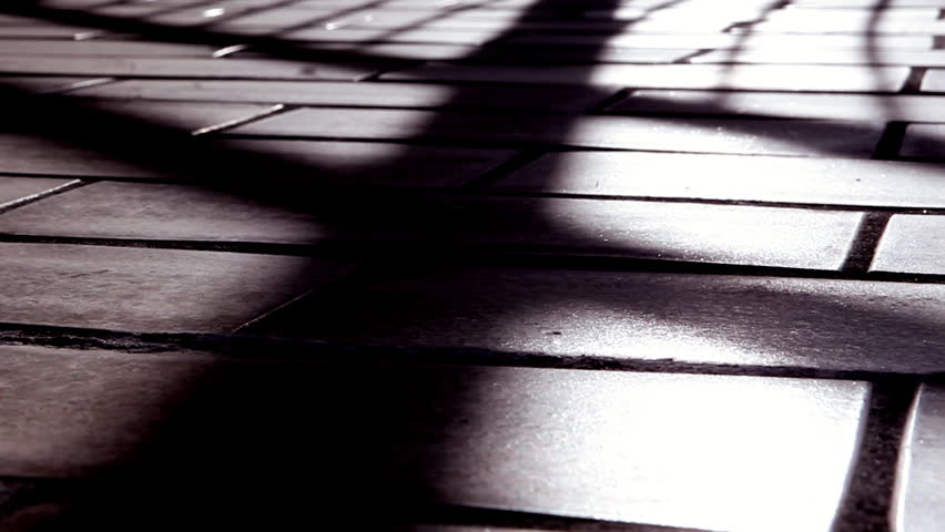Sunset shadow speed up video clip. Moving on the balcony tiles. Metal fence making shadow.