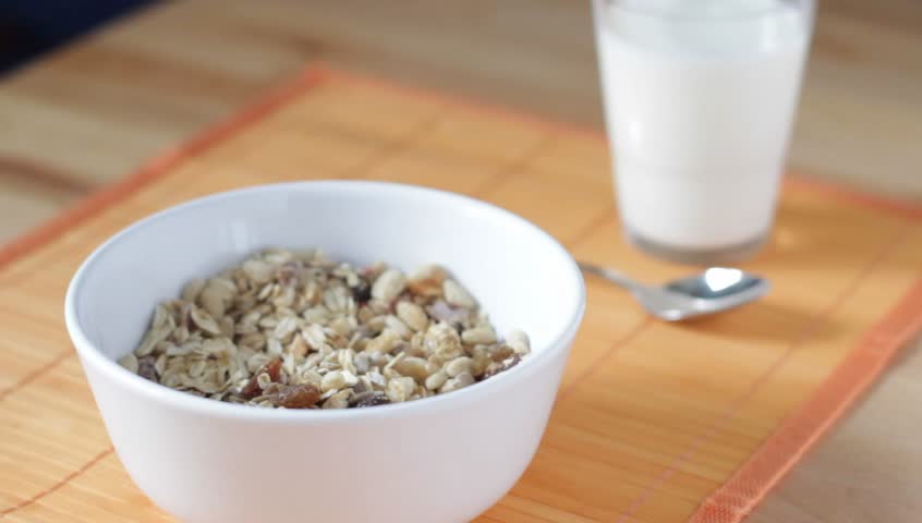cereal is poured into a bowl