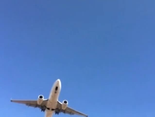 Jet airliner and commercial airplane landing with jet engine sound and the sun shinning.