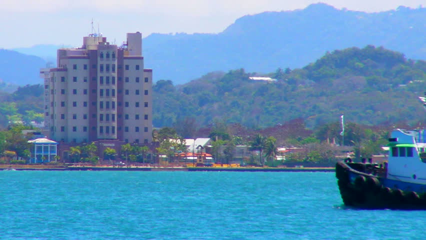 SAN JUAN, PUERTO RICO - JUN 10, 2011: Green tugboat on San Juan Harbor