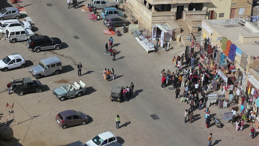 People and cars cross the streets, a group of people stands at a small shop at Jaisalmer Fort, Rajasthan, India, on January 4, 2011.