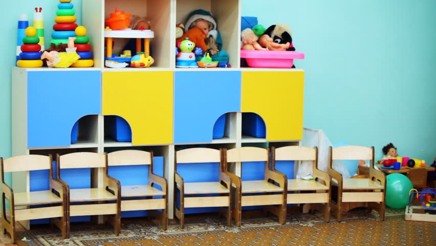 kindergarten room with colorful toys on shelves, panorama