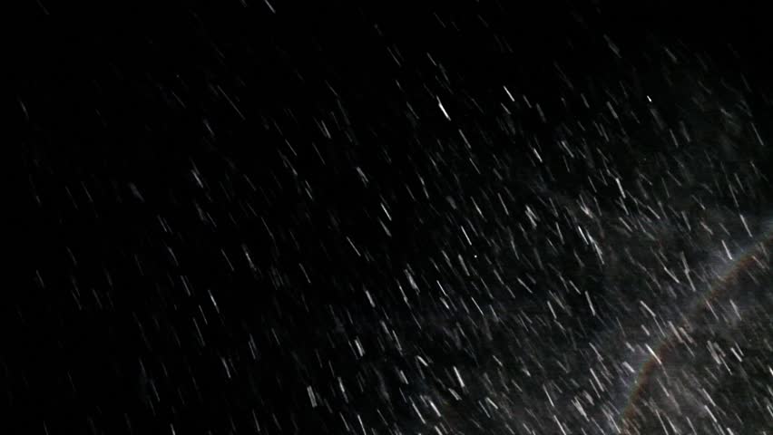 Blizzard at night under a spotlight