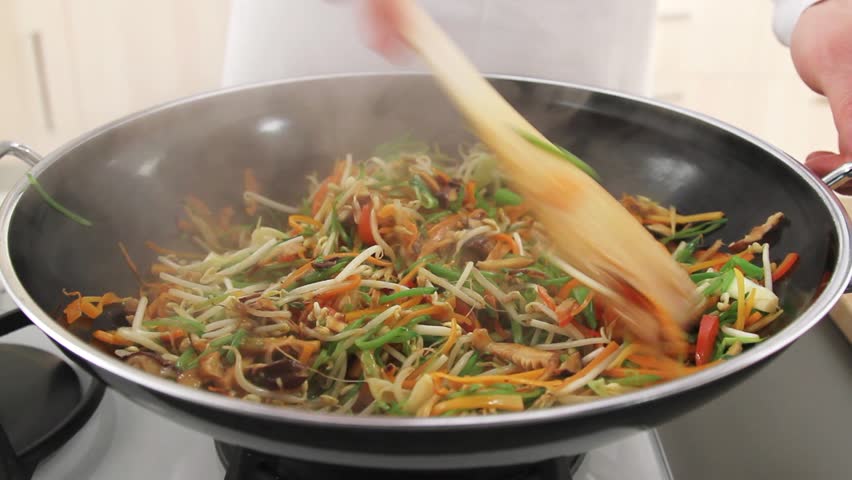 Stir-frying vegetables in a wok