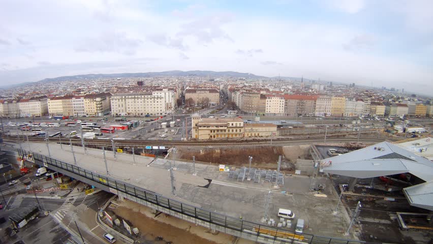 Railway station stands against city landscape, time lapse