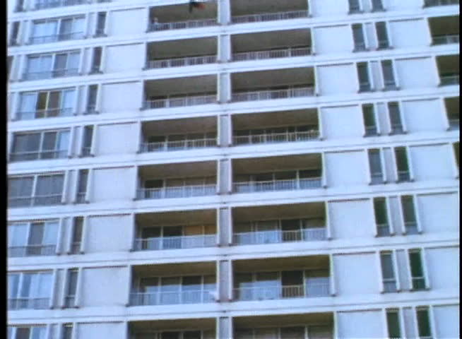 Wide shot of man falling from building
