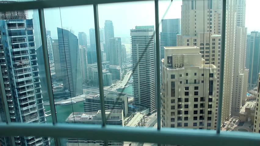 view of buildings from glass elevator