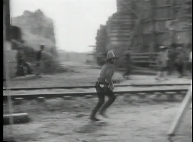 Cowboy jumping on horse from behind