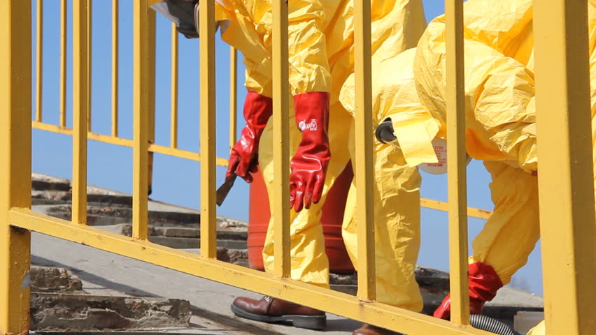 Professional  people in protective uniform removing of chemicals and dangerous materials