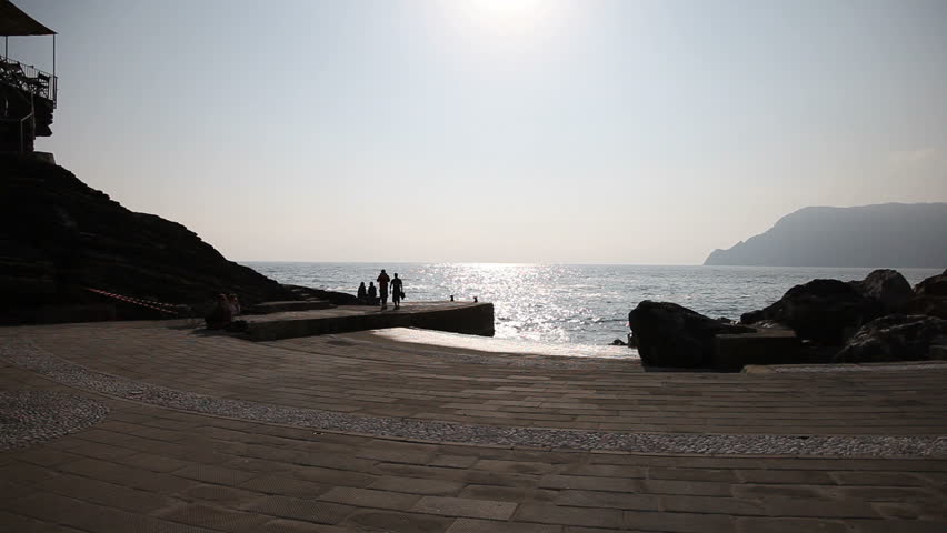 A dock in Vernazza, Cinqueterre, Liguria, with people walking around.