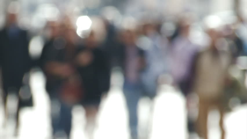 De-focused people walk in slow motion