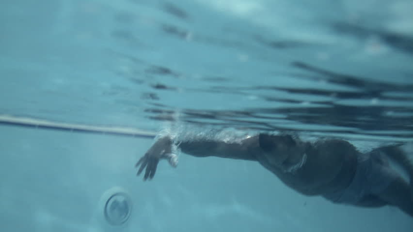 Male swimming in swimming pool in gym