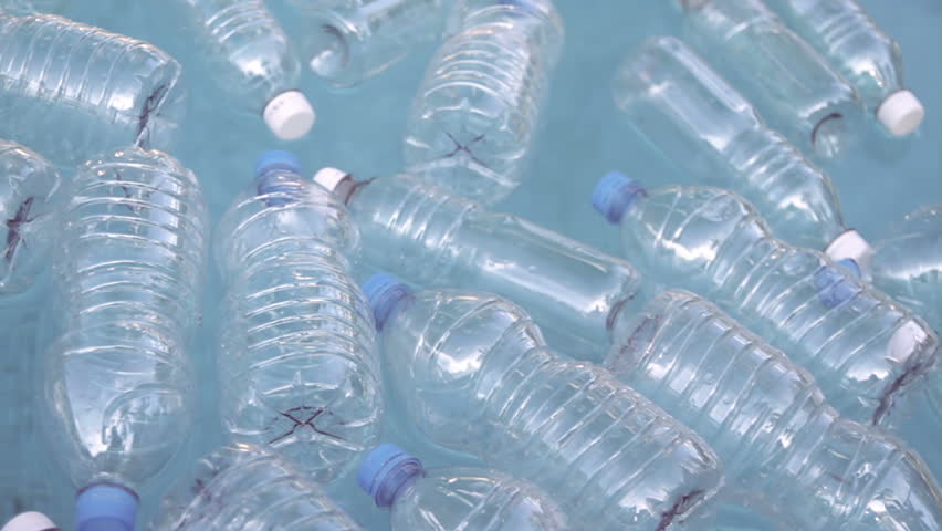 Plastic Bottles Floating On Water (HD). Plastic water bottles from different kinds floating on water.