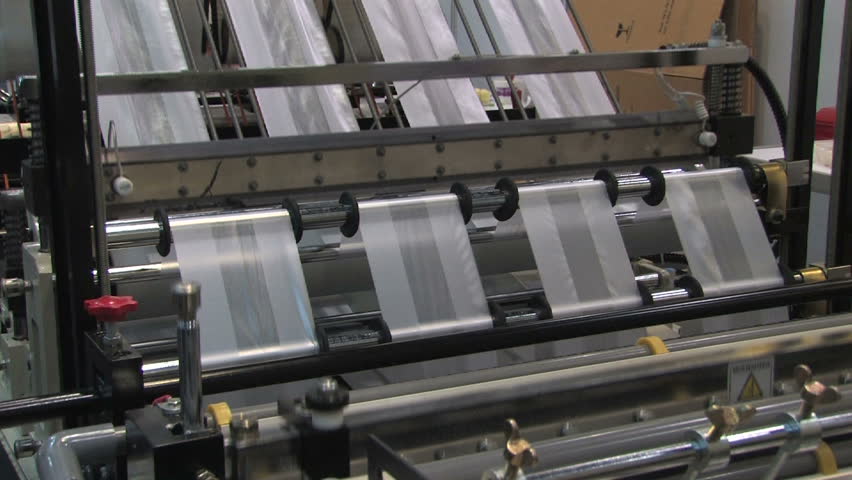 Plastic Bag Factory production line.  A plastic bag or pouch is a type of flexible packaging made of thin, flexible, plastic film. Plastic bags are used for containing and transporting foods, produce.