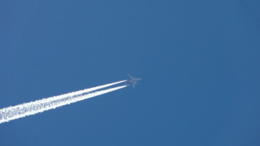 Condensation vapour trails are left behind from a passing airplane.