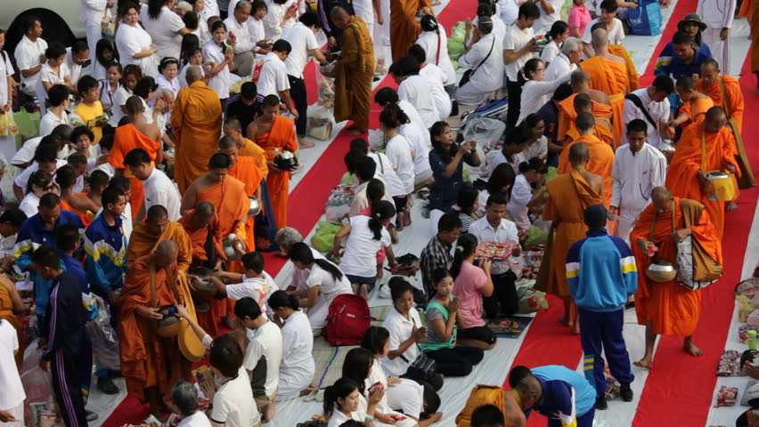 BANGKOK - MARCH 17: Monks are participating in a Mass Alms Giving of 12,600 monks for the Makha Bucha celebrations on March 17, 2012 in Bangkok, Thailand.