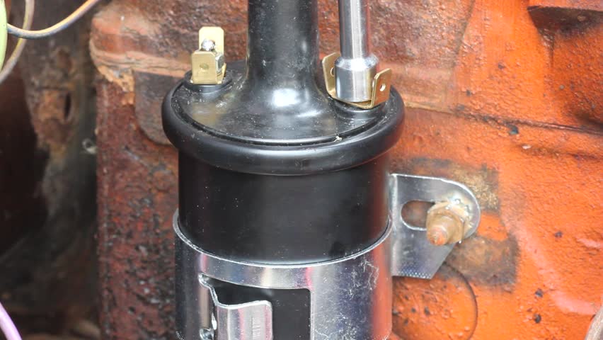 Tightening Old Style Ignition Coil Nut With Hand Driver