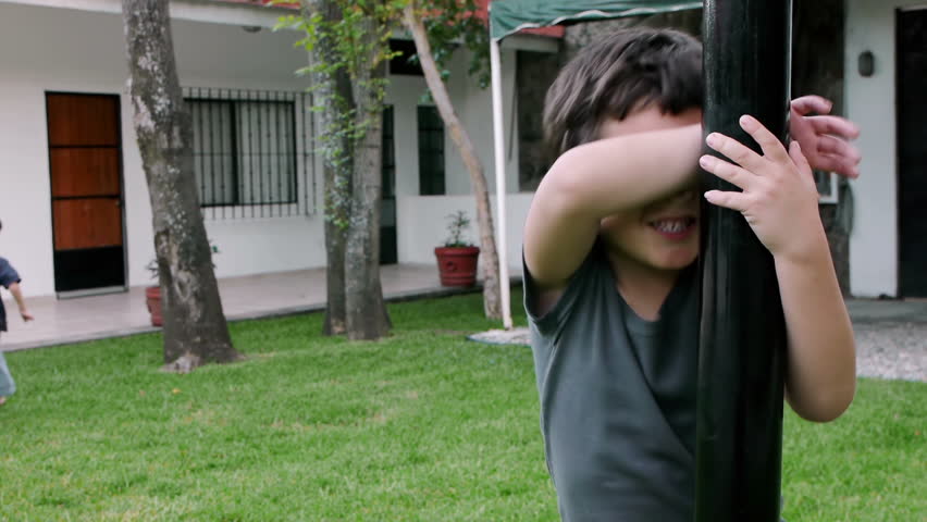 Boys Playing Hide and Seek (HD). 2 brothers of Hispanic origin; 6 and 4 years old playing hide and seek each other.Older Brother counts.Note: The younger brother suffers from a slight Lazy eye problem