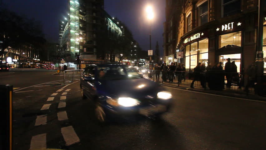 LONDON - DECEMBER 27: Busses and other traffic drive at night in a busy street in the City of London on December 27, 2011 in London, UK. The City is the financial heart of London.