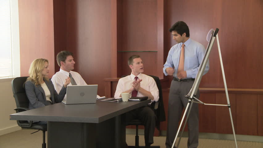 Young business man making presentation to coworkers