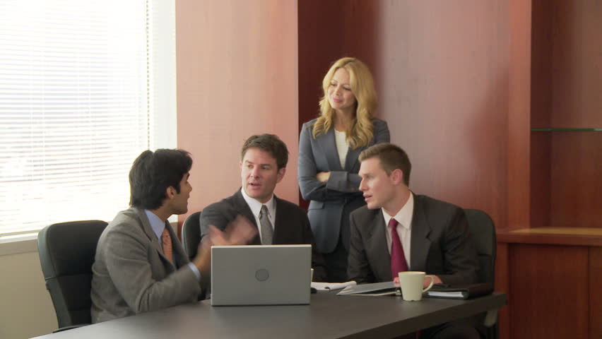 Portrait of business executive with conference in background