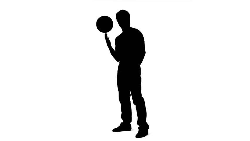 Silhouette of a man balancing a ball on his finger in slow motion against a white background