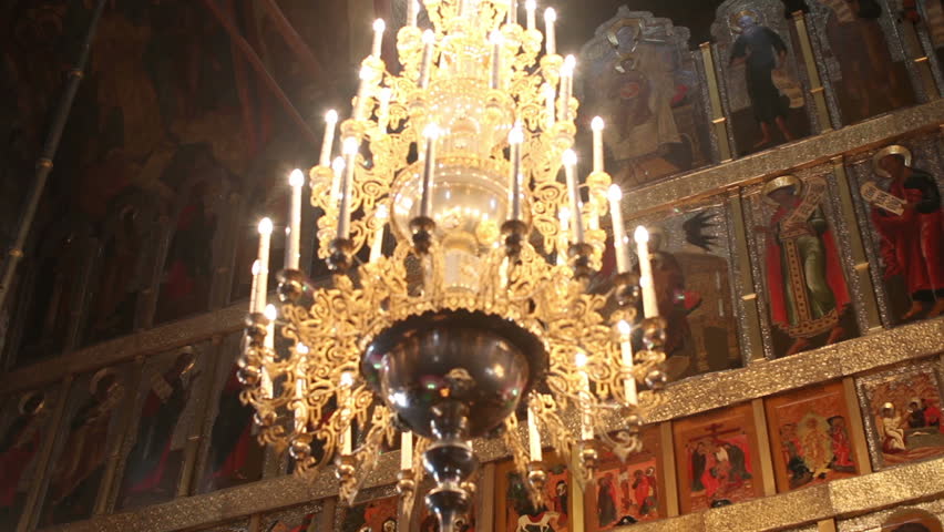 Chandelier and icons of saints in church