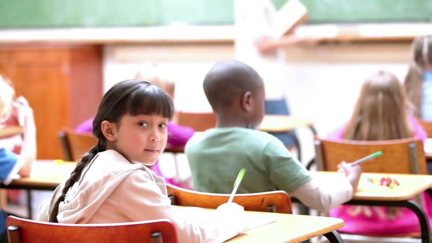 Pupils listening to the teacher in the classroom