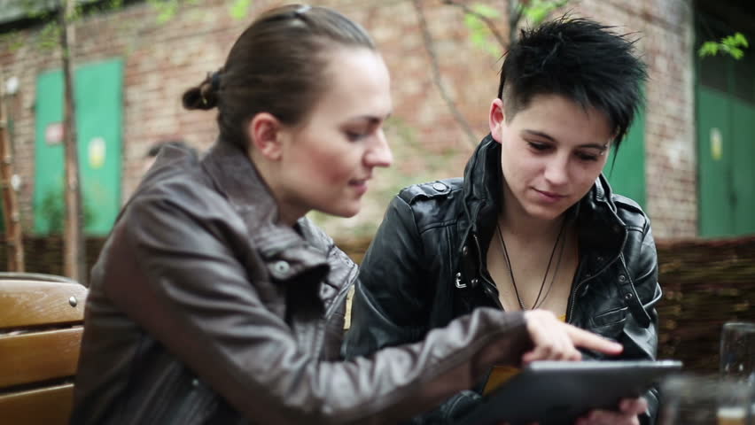 Young college students using a tablet computer, stabilized shot
